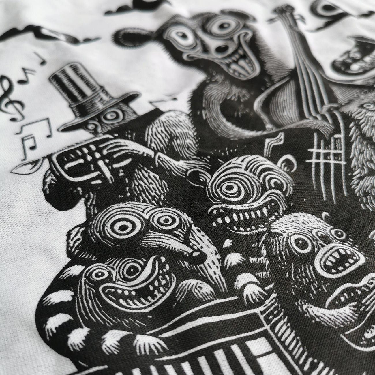 Side view of the hand screen print design of bears playing the trumpet